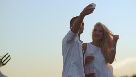 love couple with glasses of champagne taking selfie. romantic couple in love