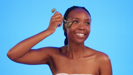 Skincare,-jade-roller-and-black-woman-in-studio