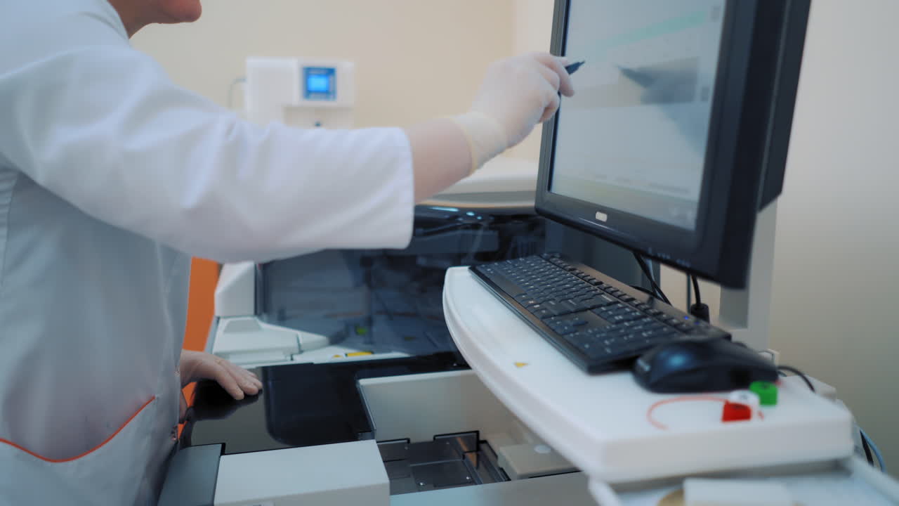 Scientist working in laboratory with computer. Research scientist using computer at workplace in laboratory