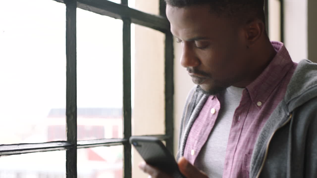 Black man, phone and coffee  drink by window