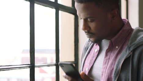 Black-man,-phone-and-coffee--drink-by-window