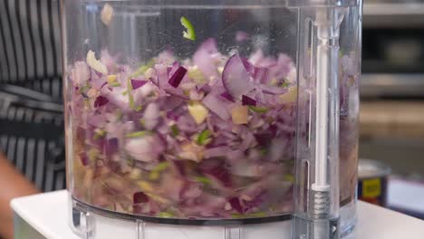 chopping and mixing red onion, pepper, cilantro, garlic and other ingredients in a food processor - chana masala series