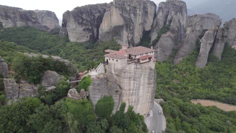 aerial arc of impressive cliff top monastery perched on massive rock column