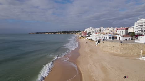 Aerial-Flying-Along-Armacao-De-Pera-Beach-Coastline-With-Waves-Gently-Breaking