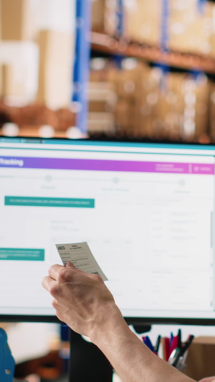 Vertical Video Asian employee typing tracking info from airway bill labels