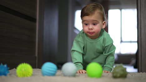 baby crawling and playing with balls