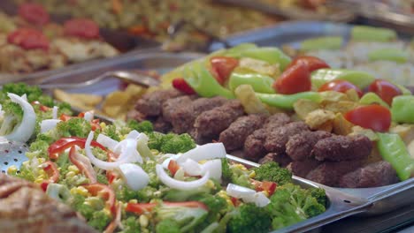 restaurant buffet with meatballs and vegetables