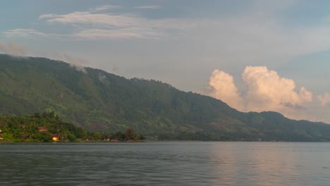 scenic lake landscape with mountains and a distant boat
