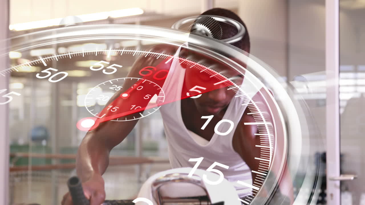 Stopwatch graphic over man using exercise bike