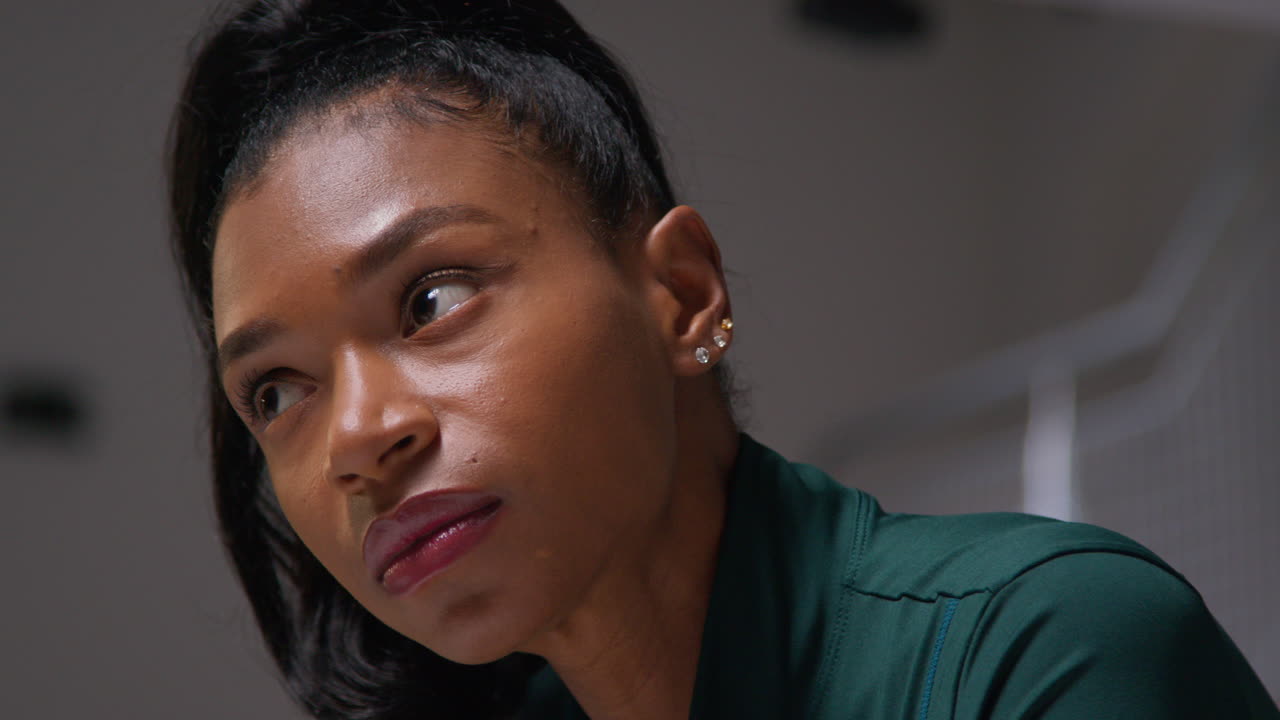 Close Up Portrait Of Determined Female Athlete Sport Training In Gym Sitting And Concentrating In Changing Room With Focused Expression 1