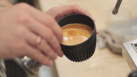 barista making latte art in coffee shop