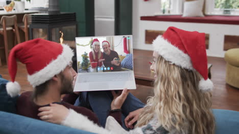 Two-happy-caucasian-couples-having-christmas-laptop-video-call,-slow-motion