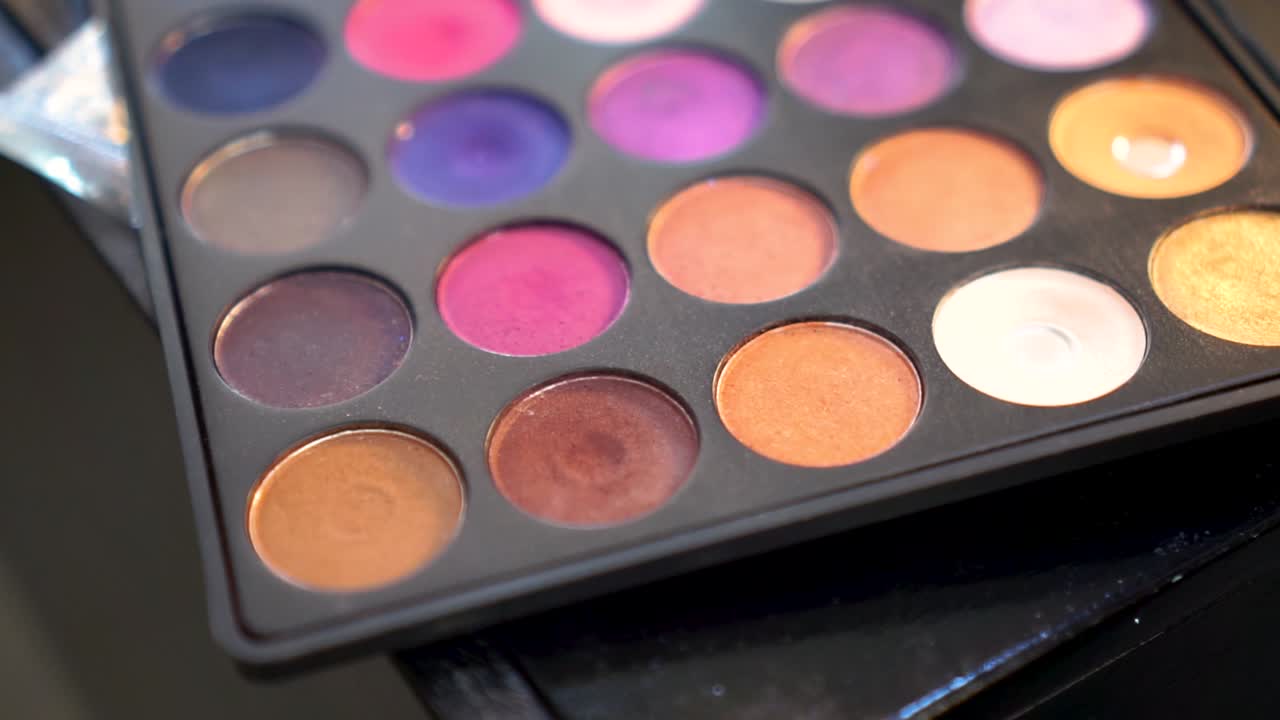 Professional multicolor makeup eyeshadows palette. Handheld, shallow focus