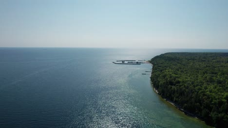 Drone-shot-of-the-heavily-wooded-northern-Wisconsin-shoreline