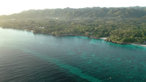 Aerial-Over-Turquoise-Waters-Beside-Coast-Of-Anda-Island