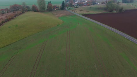 aerial view of the countryside in österlen, south sweden, small houses, farmland, cloudy, road, neighbourhood