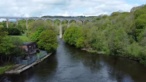 aerial view pontcysyllte aqueduct and river dee canal narrow boat bride in chirk welsh valley countryside zoom in low angle