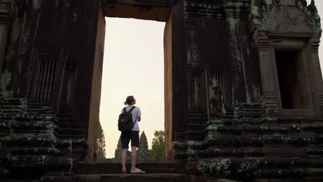 traveler exploring angkor wat temple in cambodia