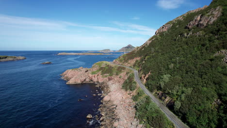 Aerial-forwarding-shot-of-the-most-dangerous-gravel-road-in-Vesteralen,-Norway,-Nyksund