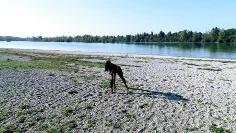 Drone-shot-of-young-attractive-black-female-doing-sports-outdoors