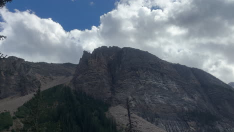 majestic mountain landscape with dramatic rock formations and lush green trees