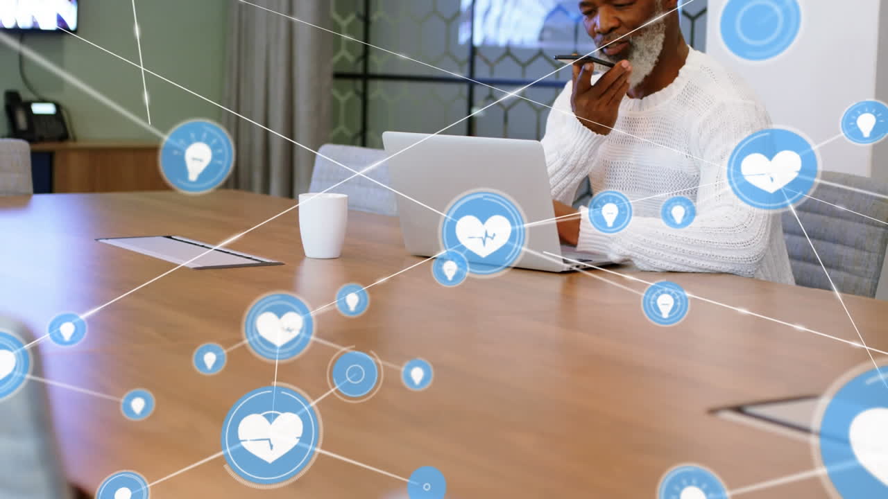 Animation of network of connection with icons over african american businessman using smartphone