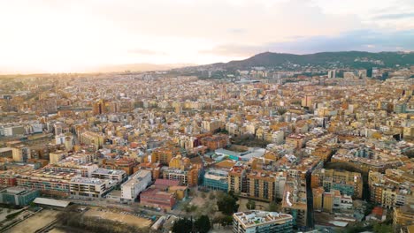 drone flying away from sunset in barcelona, spanish city