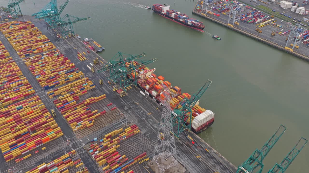 Industrial shipping port aerial footage, cargo cranes and stacks