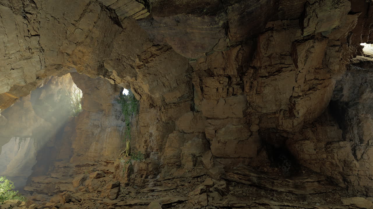 Vast rocky cave with sunlight streaming through openings and lush greenery