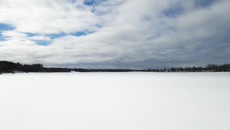 fast and long, pushing forward in harsh winds over iced lake