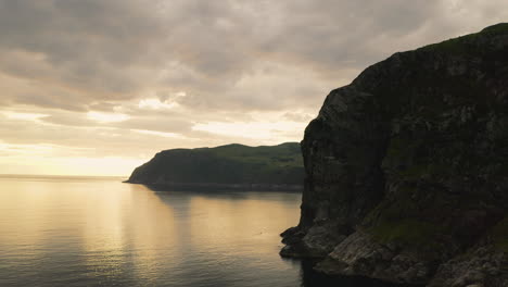 Sea-Cliff-Near-The-Town-Of-Maloy-In-Vagsoy-Island,-Norway-On-A-Cloudy-Sunset