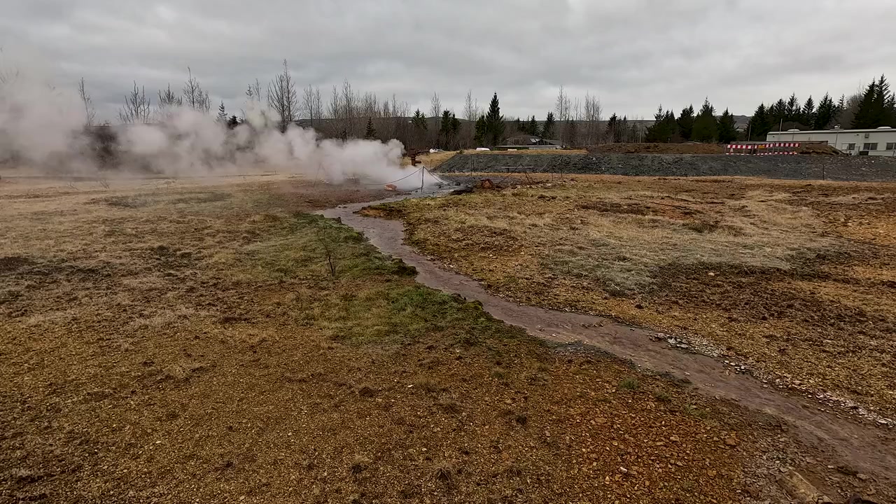 Authentic footage of a natural geothermal vent with steam rising from the ground in the Icelandic countryside. Ideal for sustainability, ecofriendly energy, and travel documentaries.