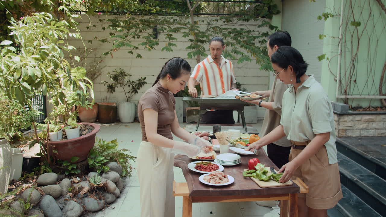 Friends Cooking for Barbecue in Backyard