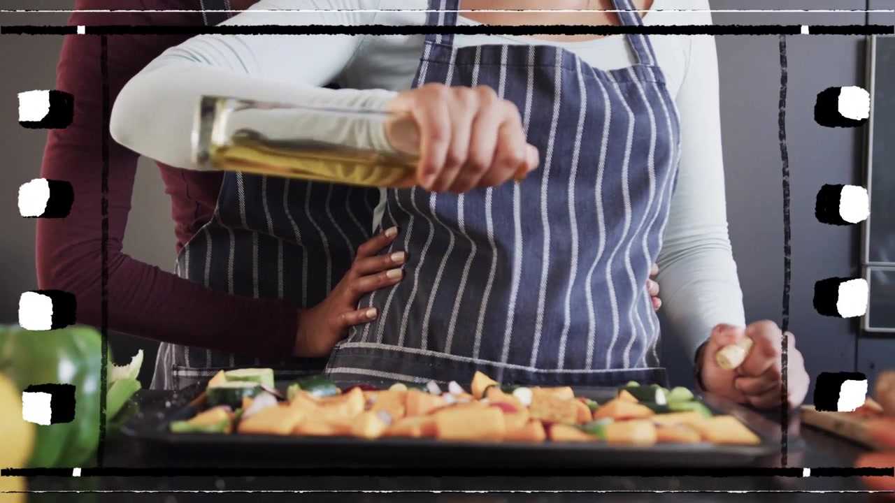 Lead woman tipping oil bottle, pouring oil dressing tray, rear partner guiding, cooking overlay