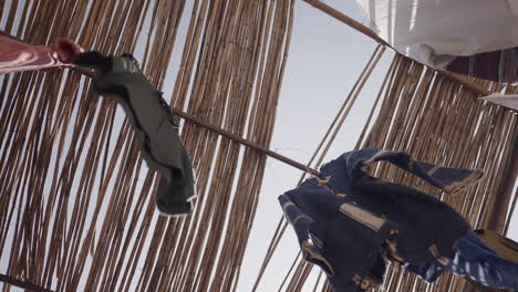 clothes drying under a bamboo roof