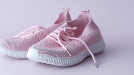 childrens shoes on light purple background