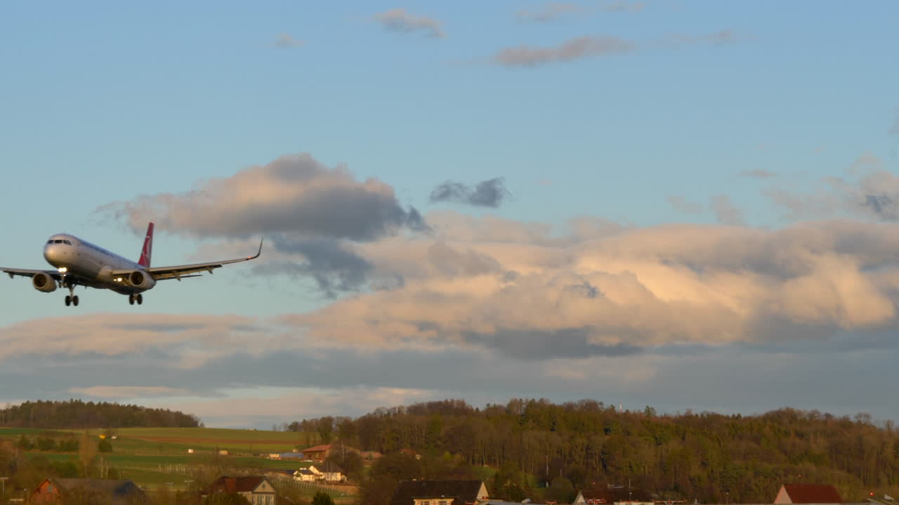 Airliner aircraft in final approach for landing on runway. Zürich, Switzerland.