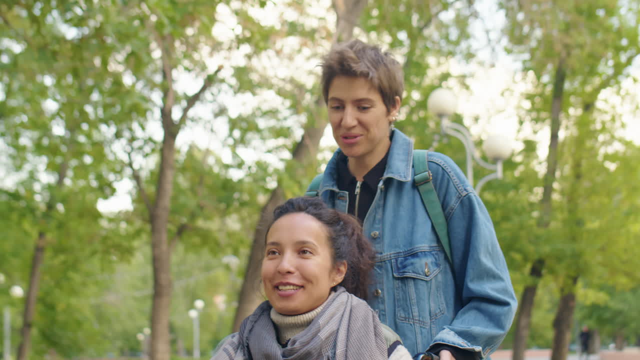 Woman on Wheelchair Enjoying Walk with Friend