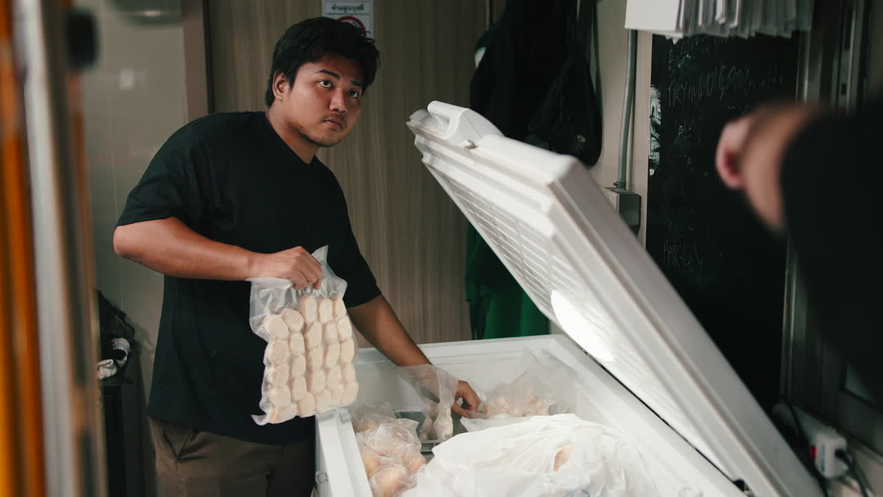 Man getting food from freezer