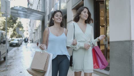 young brunette ladies looking each other, smiling and chatting