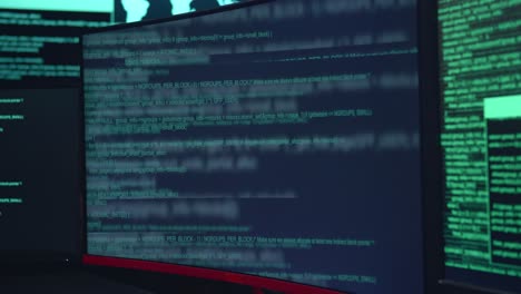 code on multiple computer screens, cyber attack