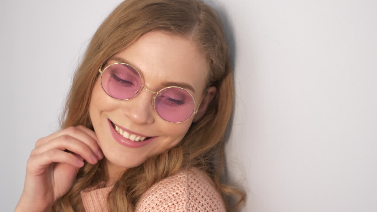 Woman wearing pink round glasses