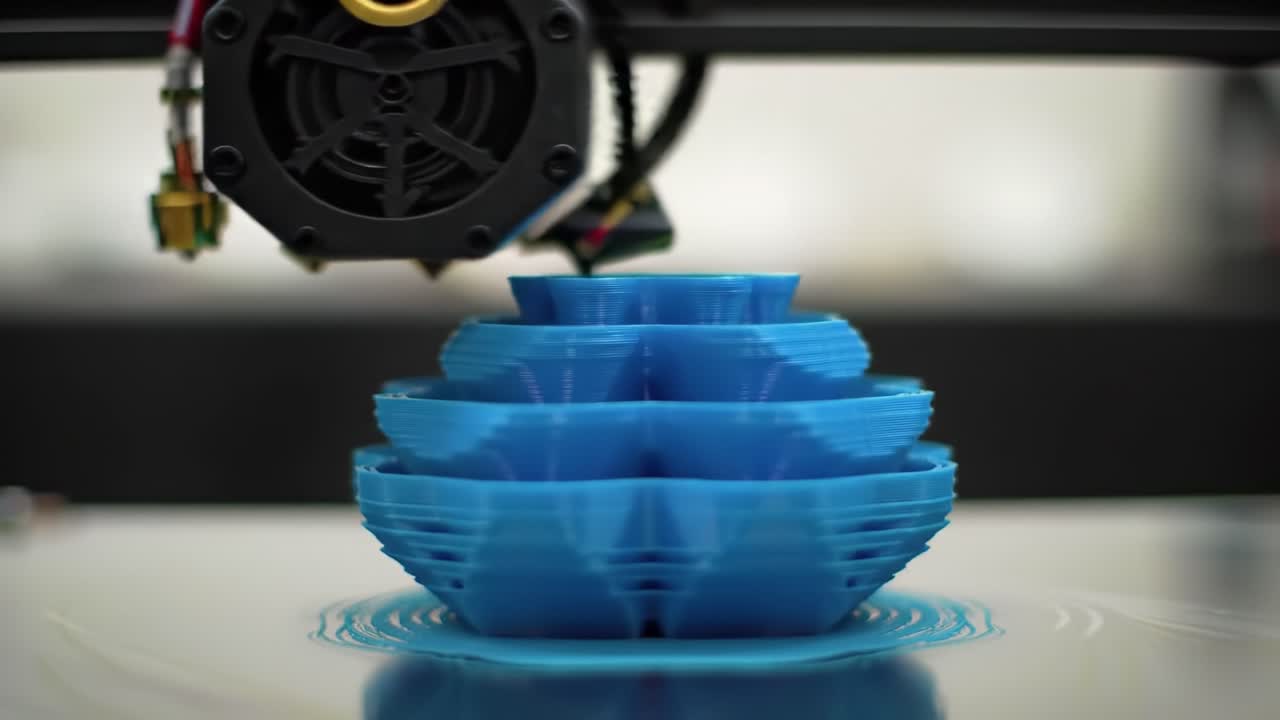 An Intricate Blue Objet Created by a 3D Printer Layering Technique, Showcasing the Evolution of Design Through Each Layer as the Print Progresses