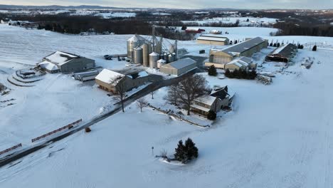 large grain farming operation and buildings in winter snow