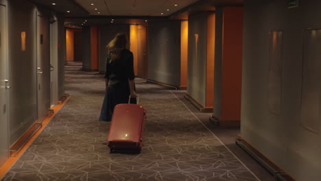 hotel guest with trolley case walking to the room