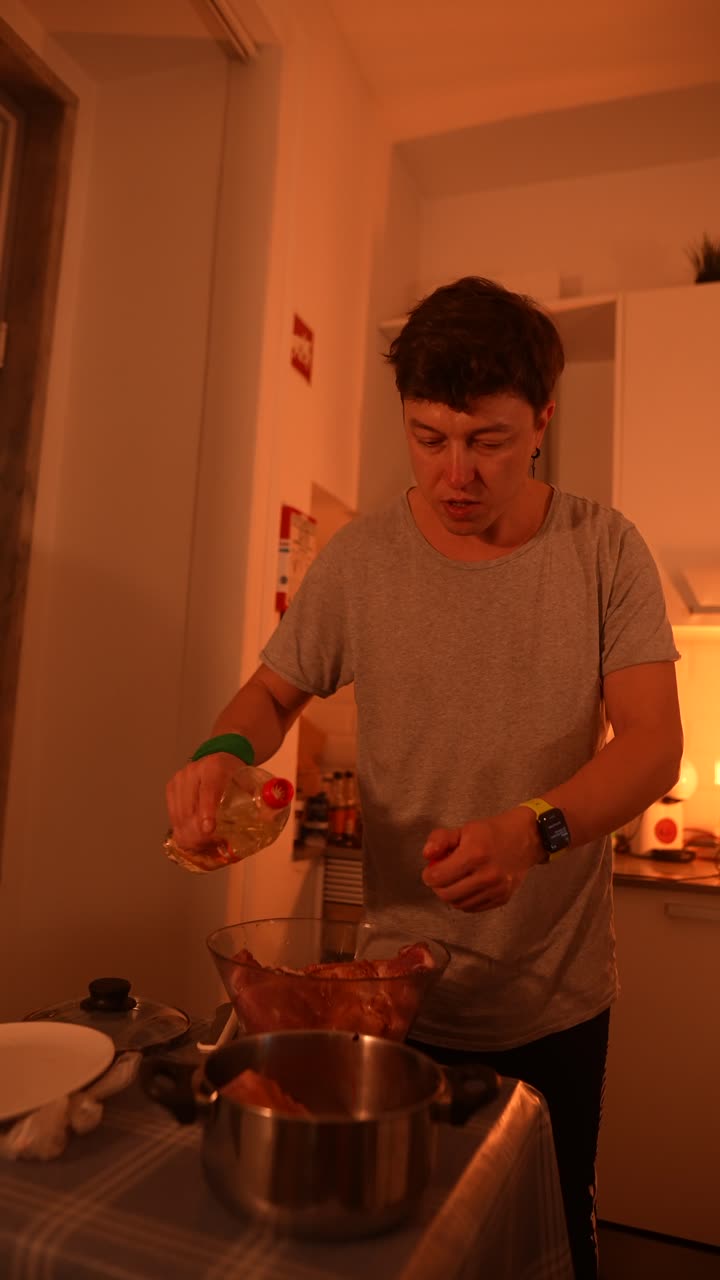 Person Cooking Meat in Kitchen