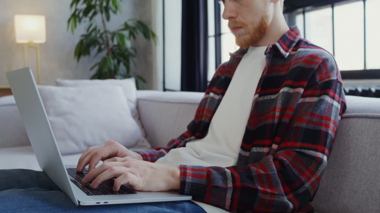 Man Working on Laptop at Home