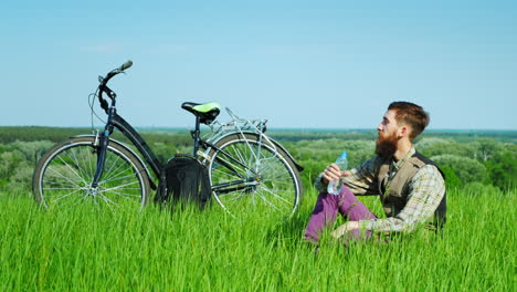 a young cyclist drinks water 1