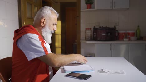 the poor man does financial calculations by looking at bills and has little money.