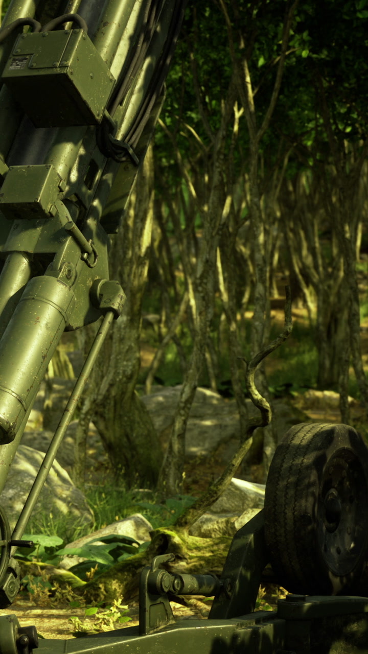 Military equipment sits in forest during training exercise at daytime